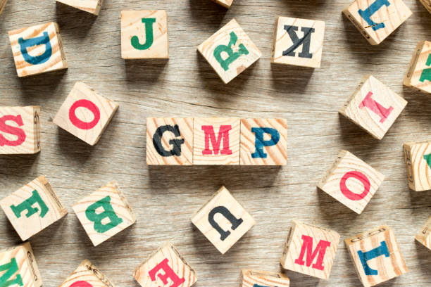 istock Letter block in word GMP with another on wood background 921108820