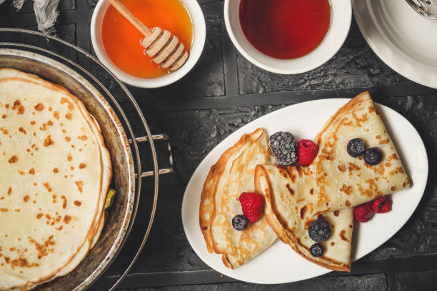 istock Pancakes (crepes) on a wooden surface 921112096