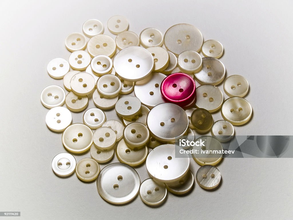 Buttons Red button standing out among white buttons Button - Sewing Item Stock Photo