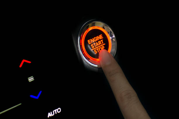 istock Fingers pressing car start button - Finger on the button 921141642