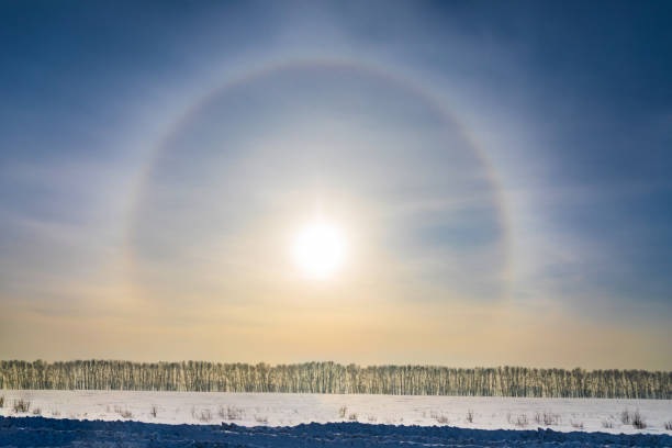 istock Halo around sun on blue sky in winter time 921142620