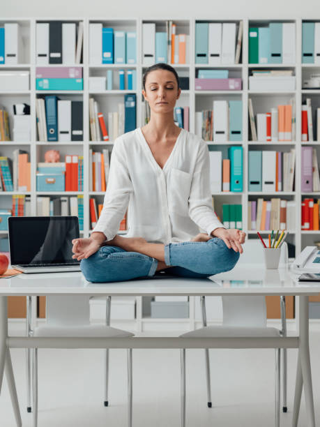 istock Woman practicing meditation on a desk 921145610