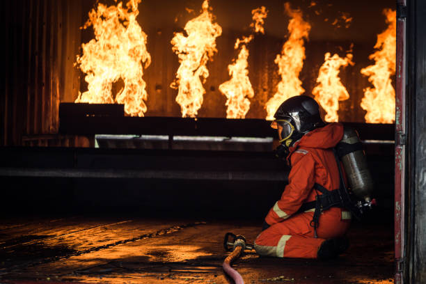 istock Firefighters training, Team practice to fighting with fire in emergency situation.Spray water to the flame 921145680