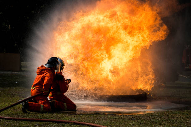 istock Firefighters training, Team practice to fighting with fire in emergency situation.Spray water to the flame 921145768