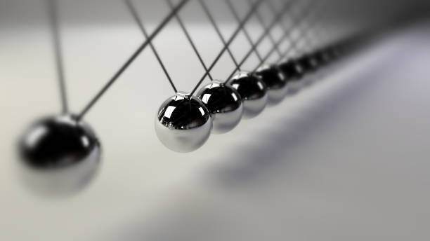 istock cause and effect concept, infinity steel Newton's cradle on a white background (3d illustration with dof) 921145928