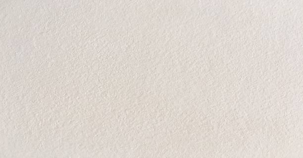 istock Grungy painted wall texture as background. Cracked concrete vintage wall background, old white painted wall. Background white painting. 921146468