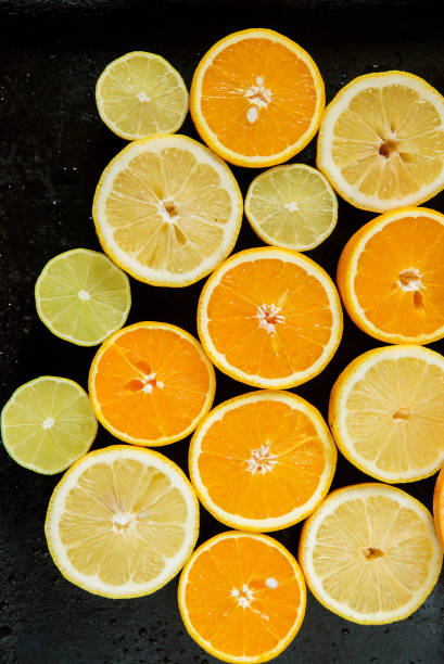 istock Citrus fruit background with sliced oranges lemons lime tangerines and grapefruit as a symbol of healthy eating and immune system boost with natural vitamins. 921146944