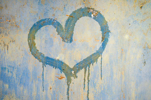 painted heart on a rusty iron background. metallic rust texture with heart shape