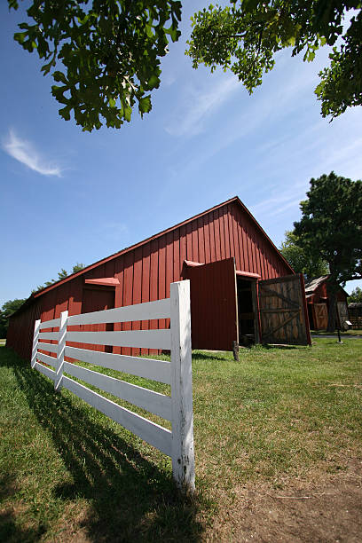 istock Red barn white fence on a farm 92114857