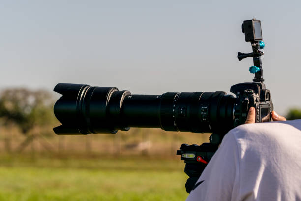 istock Photographer with a camera and a large lens 921148632