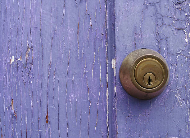 Old wooden door in lilac color, house facade front view, architecture detail