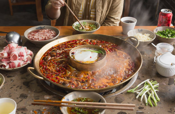 Hot pot in Sichuan, China A person is eating hotpot scene sichuan province stock pictures, royalty-free photos & images