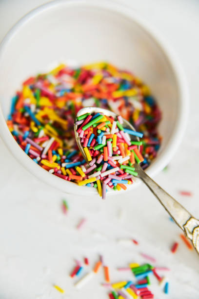 istock culinary sprinkling, cooking dressing in a Cup with a spoon on light background, close up 921154008