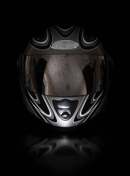 black racing motorcycle helmet on a black isolated background