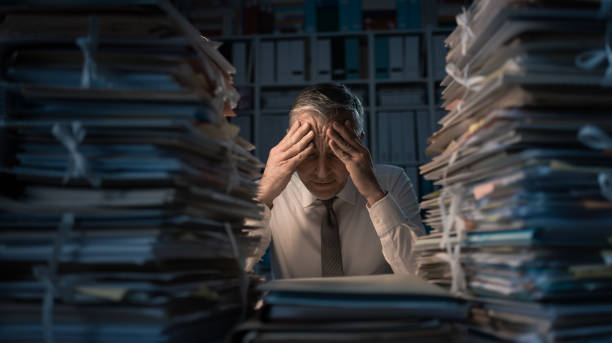 istock Desperate businessman working late 921158410