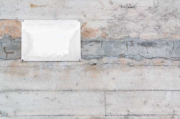 istock Old blank metal plate on concrete wall 921158670