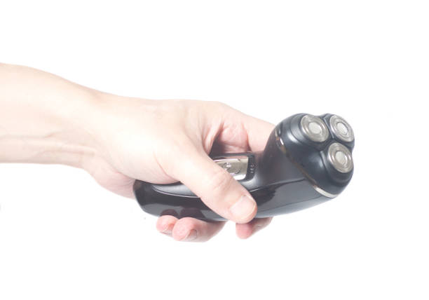istock Male hand holding electric razor shaver 921158960
