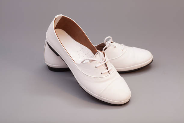 istock White Shoes on gray background 921159324