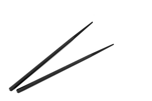 istock Pair of black chopsticks on white 921159390