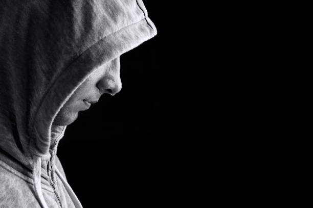 istock Athlete in hood on a black background. 921162290