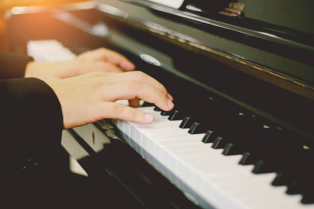 istock Soft focus, blurr Playing piano with light sunset background.and instagram style filter photo vintage tone 921162730