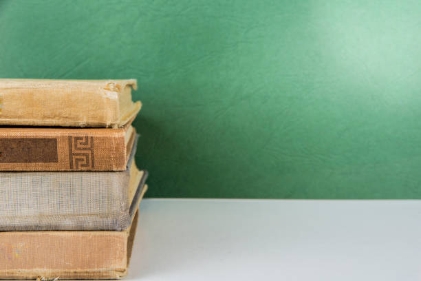 pile of old vintage book on green background - history library victorian style christianity imagens e fotografias de stock