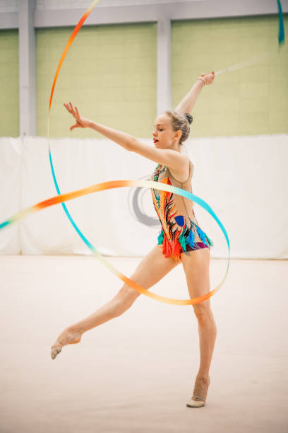 istock Cheerful Young Gymnastics Athlete Practicing with Ribbon 921176366