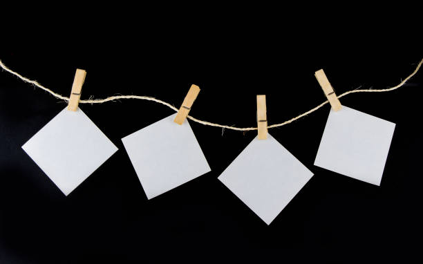 istock Clothe pin on the rope with paper note on the black background 921176610