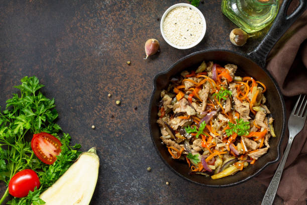 istock Warm salad with boiled meats and grilled vegetables (eggplant, carrots, paprika) on dark stone or slate background. Proper nutrition. Healthy lifestyle. Top view. 921176692