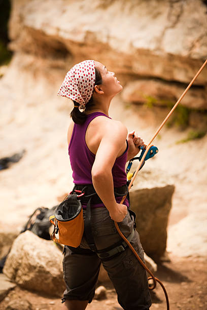 Close-up of  Female climber coating her hands in magnesium and preparing to climb.