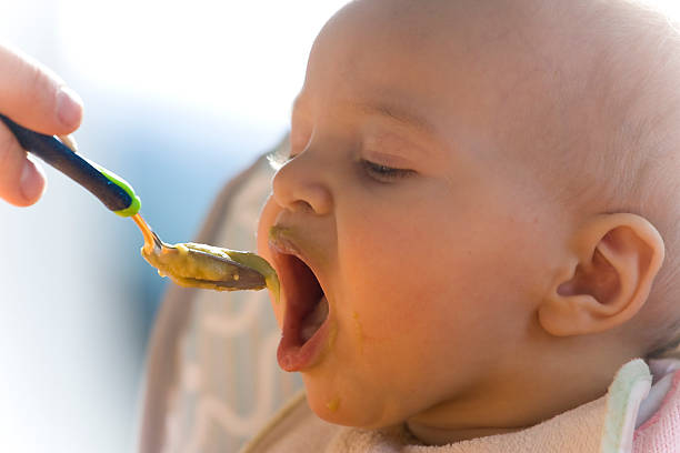 Baby is eating stock photo