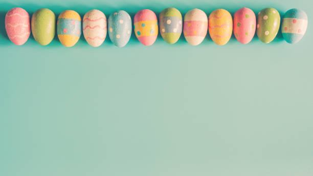 istock Colorful easter egg on green pastel color background with space. 921184098