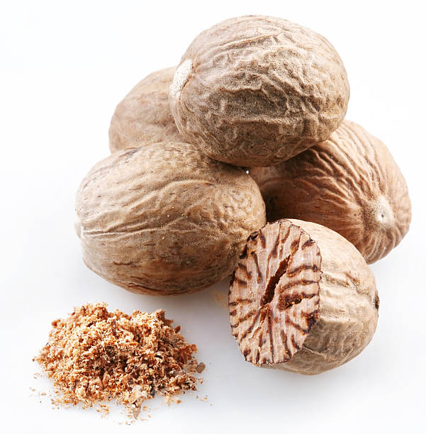 istock Four whole nutmegs, a half one and some ground nutmeg 92119497