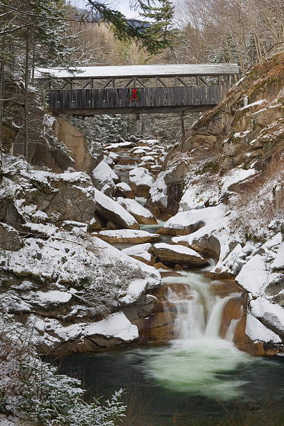 Franconia Notch Flume Series -Sentinel Pine Bridge in Early Snow stock photo