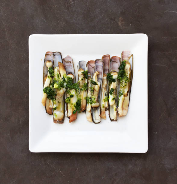 Cooked Razor Clams in green garlic sauce Cooked Razor Clams in green garlic sauce razor clam stock pictures, royalty-free photos & images