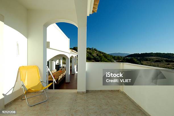 Bianco Di Villeggiatura Balcone Con Sedia In Estate Giallo - Fotografie stock e altre immagini di Alberato