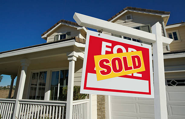 Sold Home For Sale Real Estate Sign and House stock photo