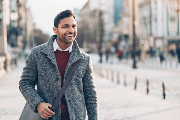 istock Smiling young man walking on the street 921225558