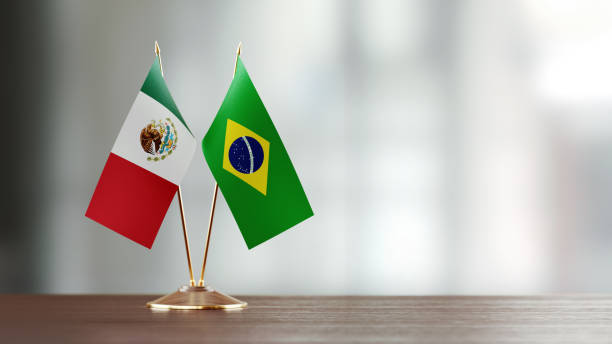 istock Mexican And Brazilian Flag Pair On A Desk Over Defocused Background 921228134