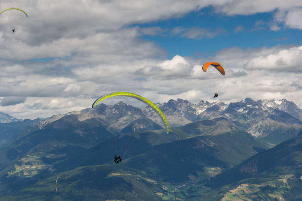 istock paragliding flying through the Alps 921236102