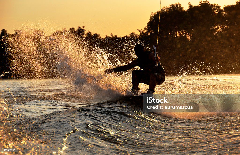 A silhouette photograph of a wakeboarder riding a wave Please see some similar images from my portfolio: Wakeboarding Stock Photo