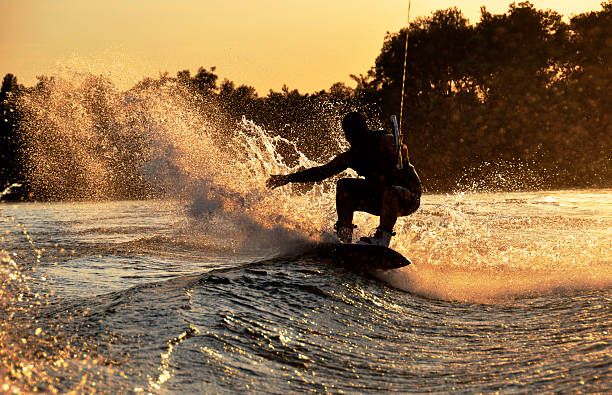 wakeboarder - wakeboarding waterskiing water ski sunset стоковые фото и изображения