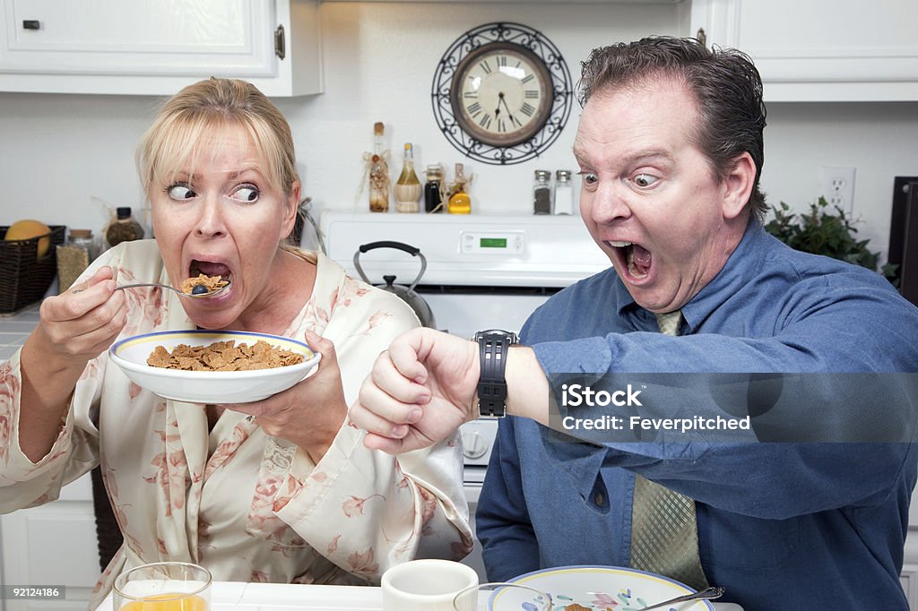 Stressed Couple in Kitchen Late for Work  Urgency Stock Photo