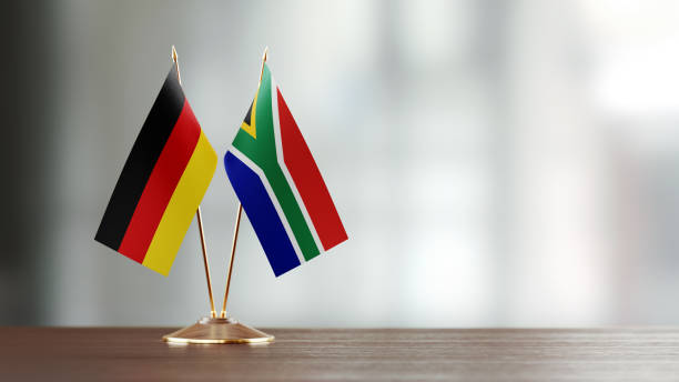 istock German And South African Flag Pair On A Desk Over Defocused Background 921249988