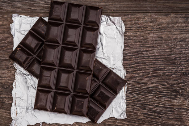 istock Dark Chocolate Bars on Foil and Wooden Table 921250350