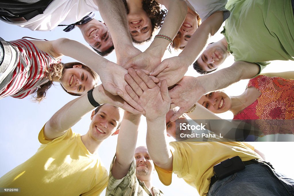 Group of nine friends keep for hands  Adult Stock Photo