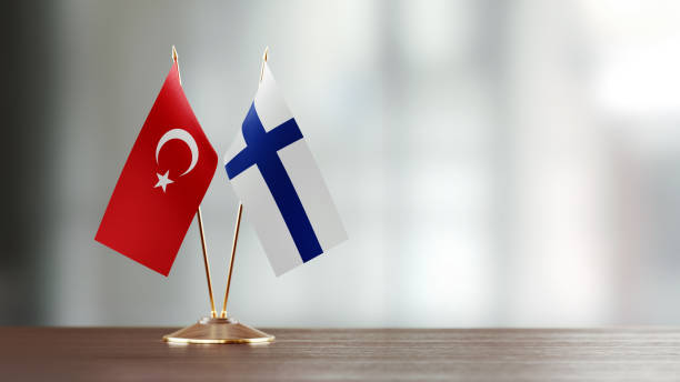istock Turkish And Finnish Flag Pair On A Desk Over Defocused Background 921257582