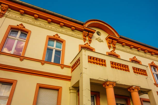 istock historical yellow house with orange ornaments 921257930