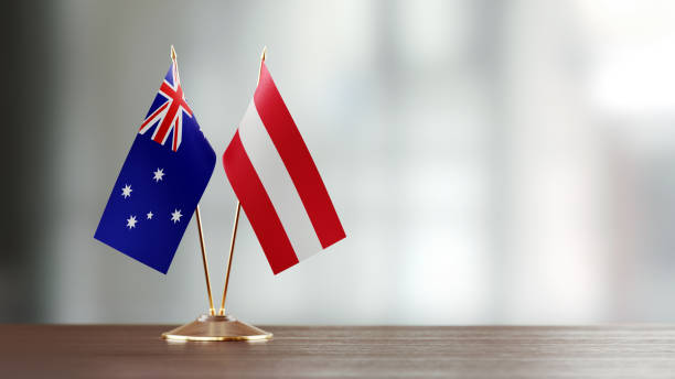 istock Australian And Austrian Flag Pair On A Desk Over Defocused Background 921259530
