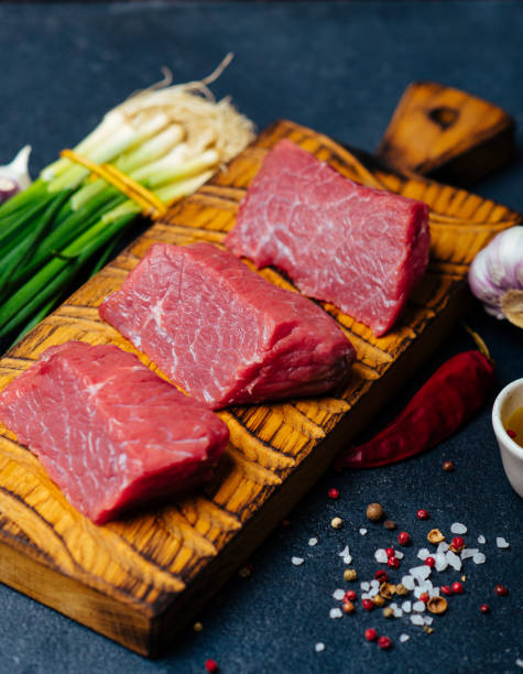 istock Raw beef meat on a wooden cutting board 921260142